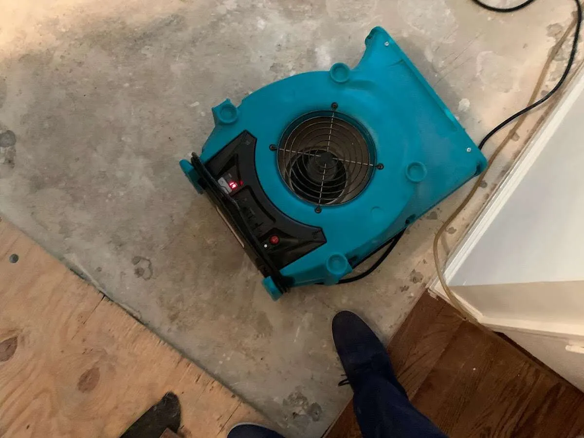 Air mover drying subfloor during Leak Detection & Repair in Galesburg